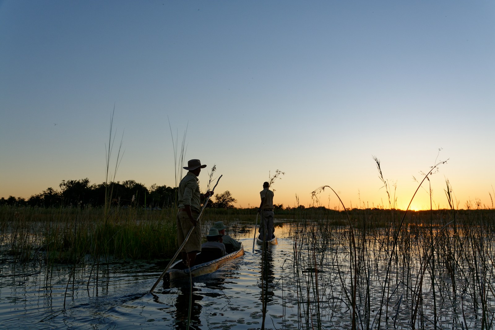 Photo by Colin Watts a group of people fishing in a river